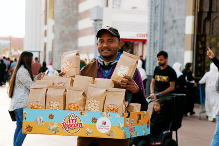 Dubai, United Arab Emirates - February 05, 2023 a man selling popcorn in dubai global villageのeditorial素材