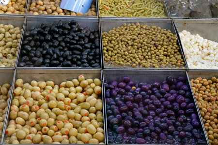 variety selection of marinated and pickled olives in a food stall for sellingの写真素材