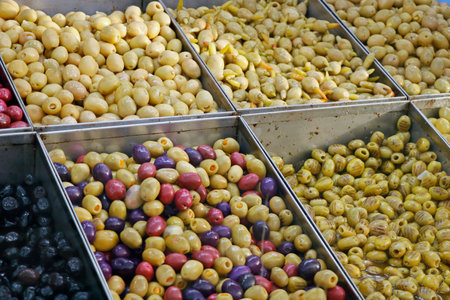 variety selection of marinated and pickled olives in a food stall for sellingの写真素材