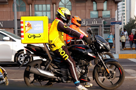 Dubai, United Arab Emirates - April 12, 2023 man on a motor bike for online deliveryのeditorial素材