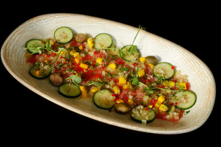 marinated yellowfin tuna crudo, similar to ceviche and tartare with lemon, cucumber, chili, mango and herbsの写真素材