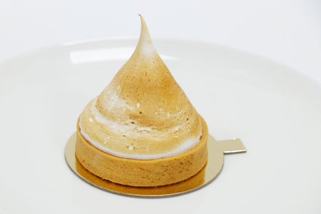 lemon tart cream with meringue dessert isolated with white backgroundの写真素材