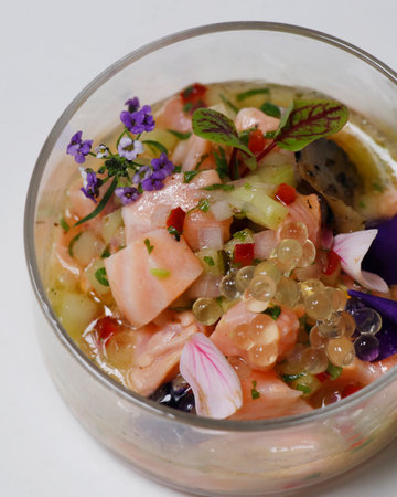 south american salmon ceviche in a glass dish with white background in close upの写真素材