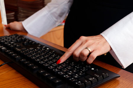 office lady finger on computer or laptop black keyboard in close upの写真素材