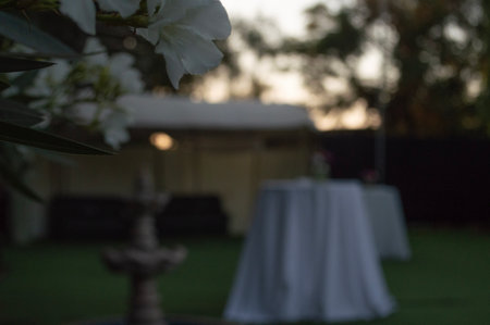 wedding ceremony in the garden with white tablecloth and chairsの写真素材