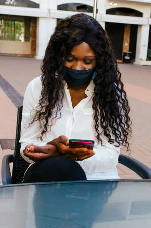 Business woman checking messages on her mobile phoneの写真素材