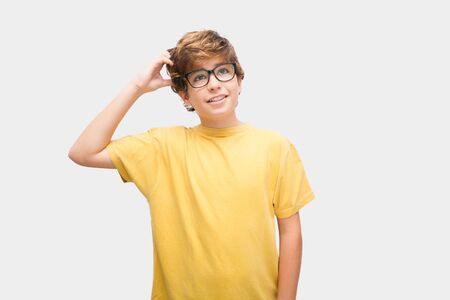 Boy with glasses looks for a way to ever study something he likesの写真素材