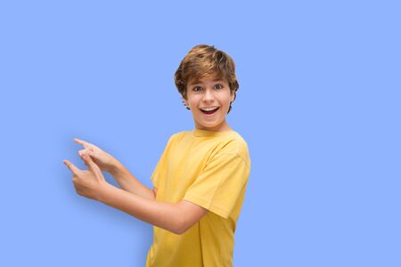 Boy shows something to his right with optimismの写真素材