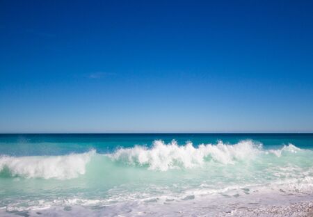 Spectacular turquoise and blue waters of the Mediterranean Sea in J?vea (Alicante). shore wave breakingの写真素材