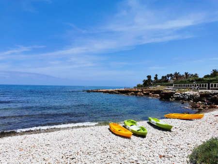 Active rest, sport, kayak. Boat for rafting on water. A few kayaks stand on a sandy beach.の写真素材