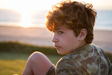 Portrait of a happy boy at sunsetの写真素材