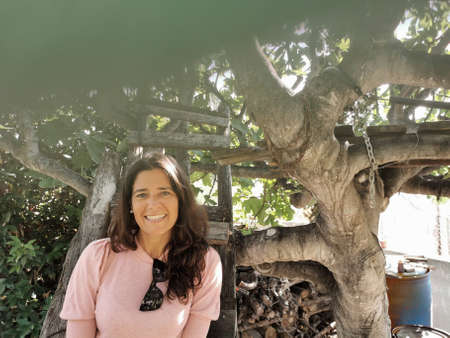 Portrait of an attractive brunette Spanish womanin a tree