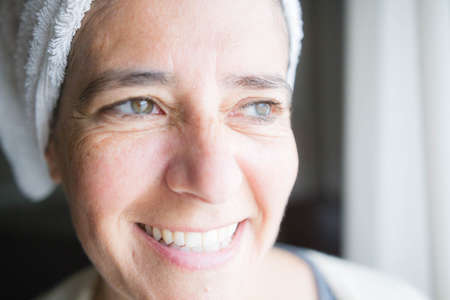 Face and body care with creams. Happy middle-aged womanの写真素材