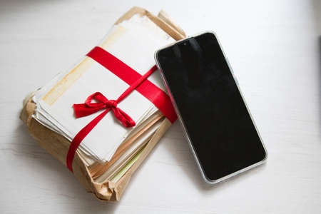 Differences between handwritten letters, antique gifts vs. modern technologiesの写真素材