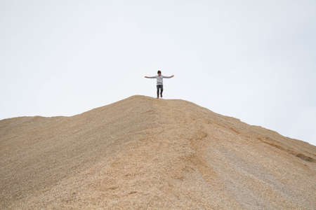 A person climbing to the top and achieving happinessの写真素材