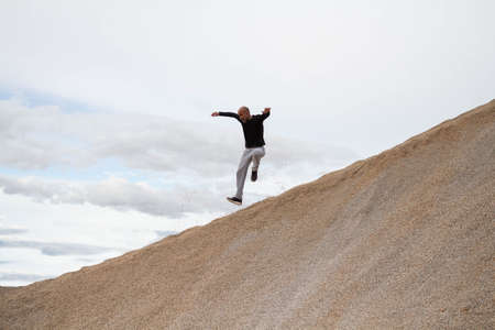 A person climbing to the top and achieving happiness