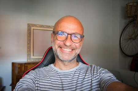 selfy of happy bald man with glasses insideの写真素材