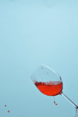 Wine bottle with transparent glass goblet, camera splash effect.の写真素材