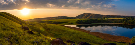 Panoramic view of the lake in the mountains at sunset.の写真素材