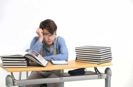 Student sitting at his desk distractedの写真素材
