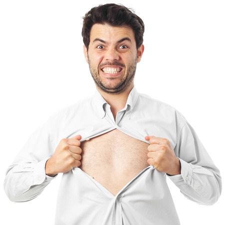 young man acting like a super hero and tearing off his shirt onの写真素材