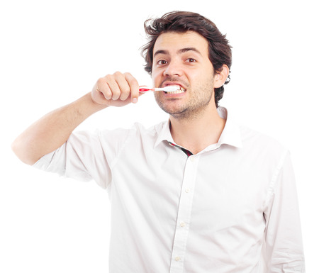 young man brushing teethの写真素材
