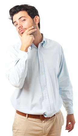 young handsome man with hand on chin imagine gesture on a white backgroundの写真素材