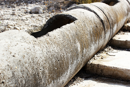 Aged and cracked concrete pipe for watering.の写真素材