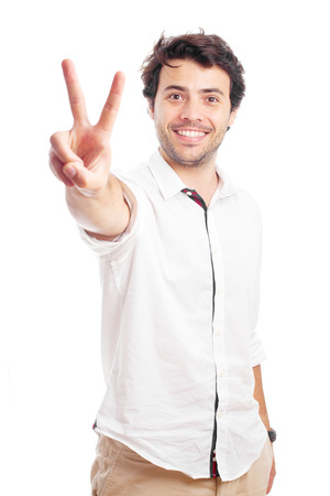 man doing victory symbol on a white backgroundの写真素材