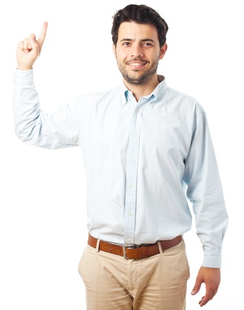 young man pointing up on a white backgroundの写真素材
