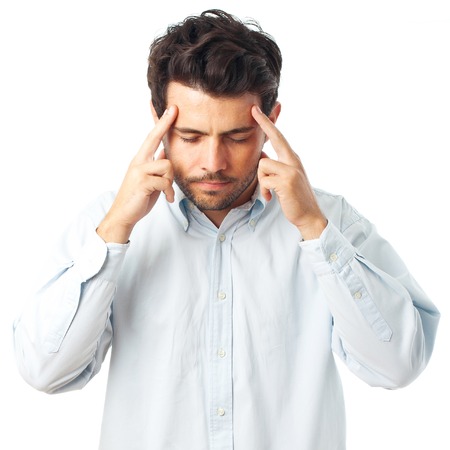 man concentrating with fingers on temple on a white backgroundの写真素材