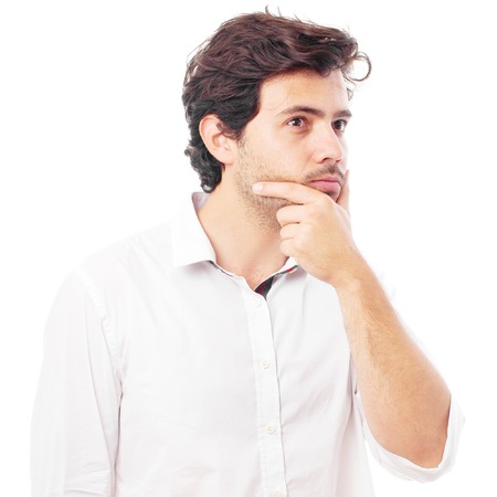 young handsome man doubting isolated over white backgroundの写真素材