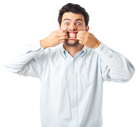 young man opening mouth with hands on a white backgroundの写真素材