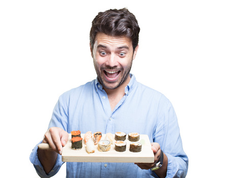 Young man eating sushi on white backgroundの写真素材