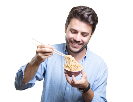 Young man eating sushi on white backgroundの写真素材