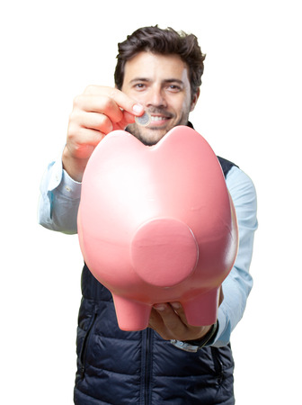 Man with vest insert coin on pigの写真素材