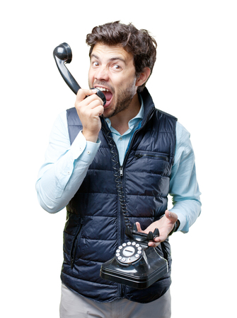 Man with vest speaking on telephoneの写真素材