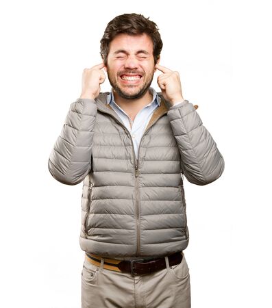 Worried man covering his earsの写真素材