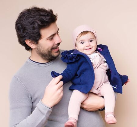 Daddy with baby flying on armsの写真素材