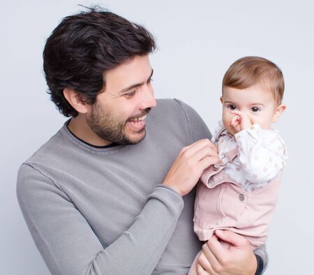 young baby with father over white backgroundの写真素材