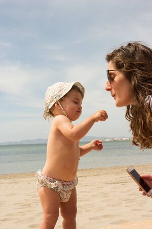 baby with mother in the beachの写真素材