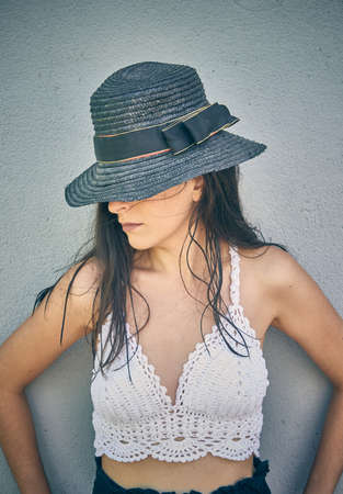 A beautiful woman in a black hat