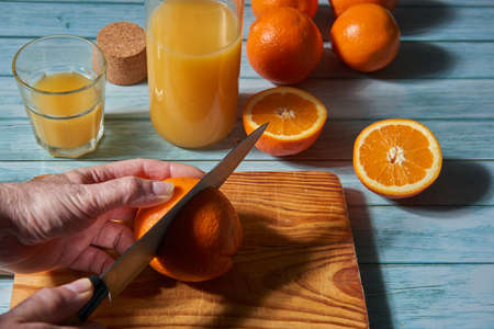 Several cut oranges on a wooden tableの写真素材
