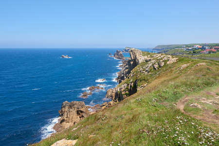 Whimsical rock formations with a turquoise blue sea and a beautiful blue sky.の写真素材