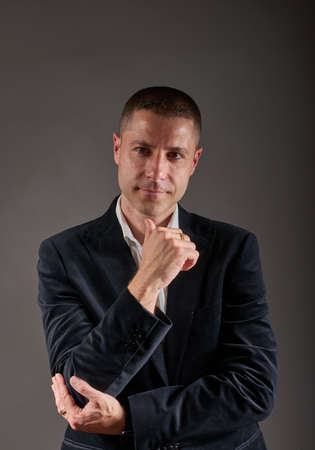 A young, elegant man dressed in a white shirt and black jacketの写真素材