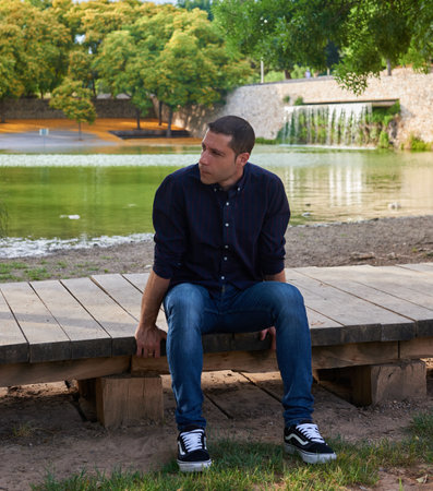 A young model in jeans posing in a relaxed pose.の写真素材