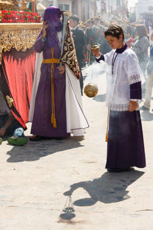 Marchena, SEVILLE, SPAIN - March 25, 2016: Procession of Holy Week(Semana Santa) in Marchena, SEVILLE. Holy Friday. Monaguillo (altar boy) fanning incenseのeditorial素材