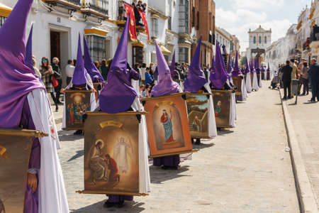 Marchena, SEVILLE, SPAIN - March 25, 2016: Procession of Holy Week(Semana Santa) in Marchena, SEVILLE. Holy Friday. The Nazarenes (penitents) carrying wooden crucifixesのeditorial素材