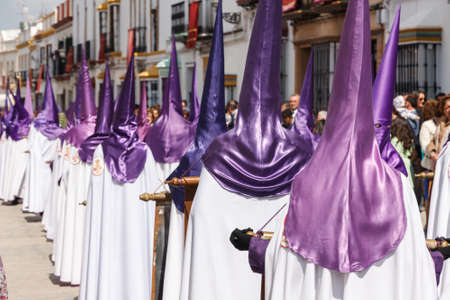 Marchena, SEVILLE, SPAIN - March 25, 2016: Procession of Holy Week(Semana Santa) in Marchena, SEVILLE. Holy Friday. The Nazarenes (penitents) carrying wooden crucifixesのeditorial素材