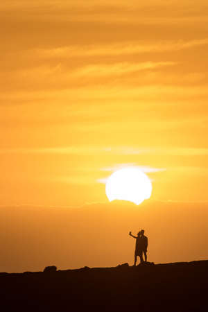 Couple of guys doing a selfie at sunsetの写真素材